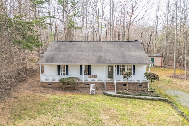 view of front facade featuring a shingled roof, a front lawn, covered porch, and crawl space