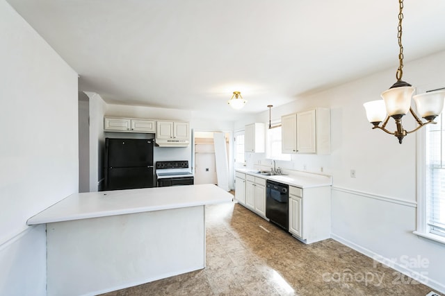 kitchen with black appliances, under cabinet range hood, a sink, light countertops, and a chandelier