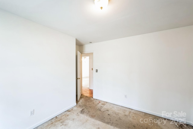 spare room featuring baseboards