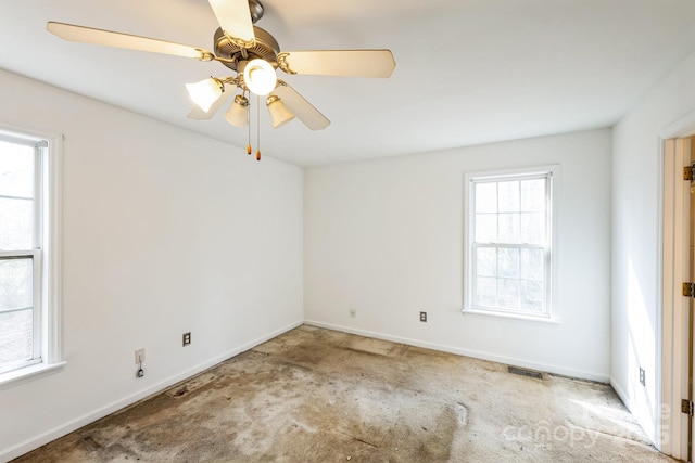 spare room with visible vents, carpet floors, baseboards, and a ceiling fan