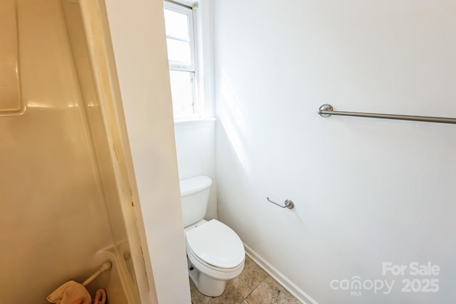 bathroom with tile patterned floors and toilet