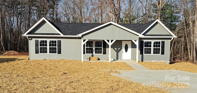 single story home featuring roof with shingles