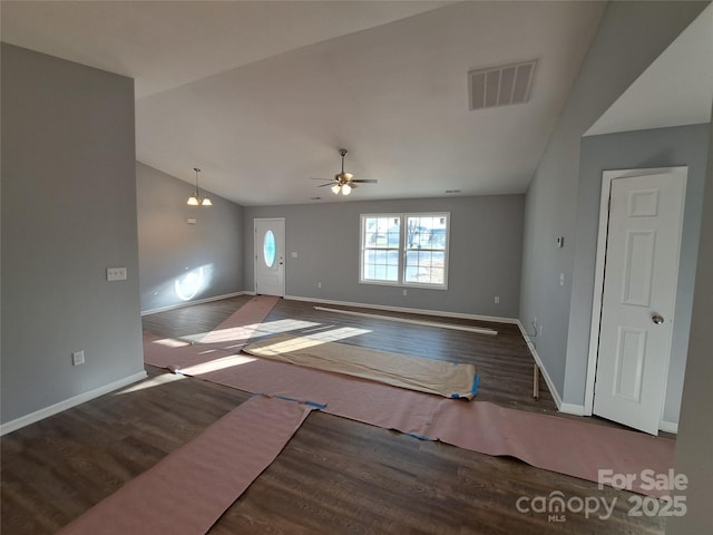 unfurnished living room with visible vents, wood finished floors, baseboards, ceiling fan, and vaulted ceiling