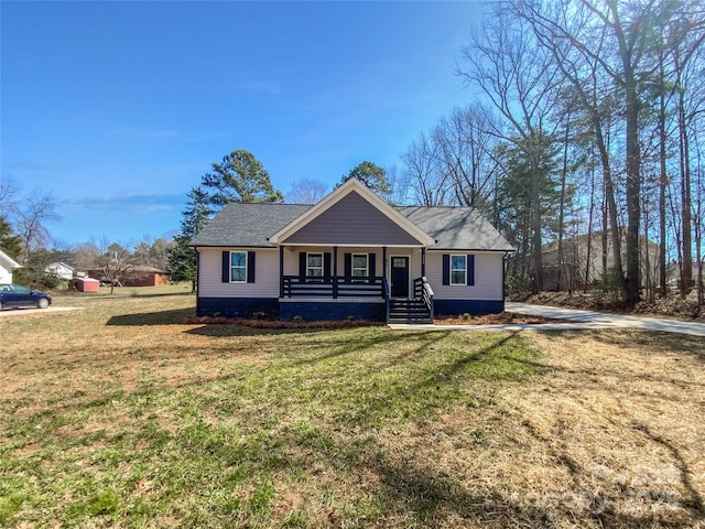 view of front of property with covered porch, a front yard, and a shingled roof