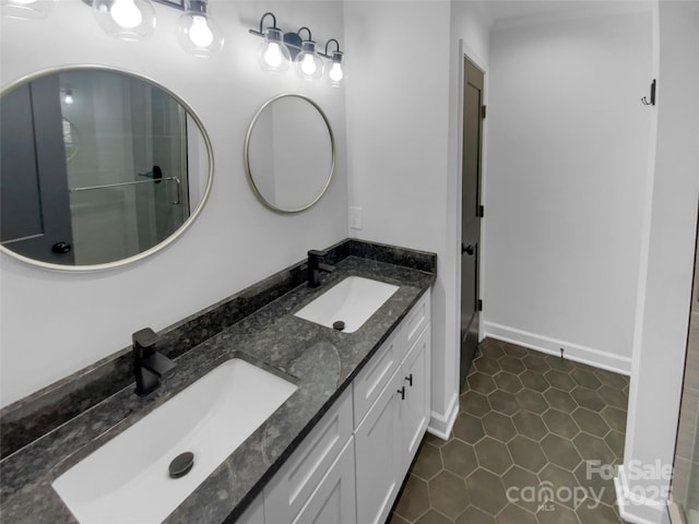 bathroom featuring tile patterned floors, double vanity, baseboards, and a sink