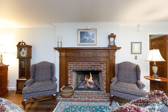 living room featuring a fireplace, crown molding, wood finished floors, and baseboards