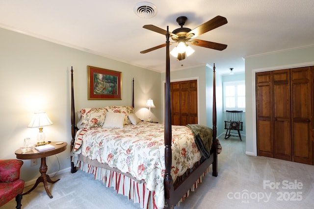 bedroom featuring baseboards, visible vents, ceiling fan, light carpet, and crown molding