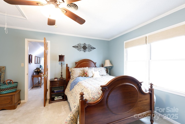 bedroom featuring ceiling fan, baseboards, attic access, ornamental molding, and light carpet