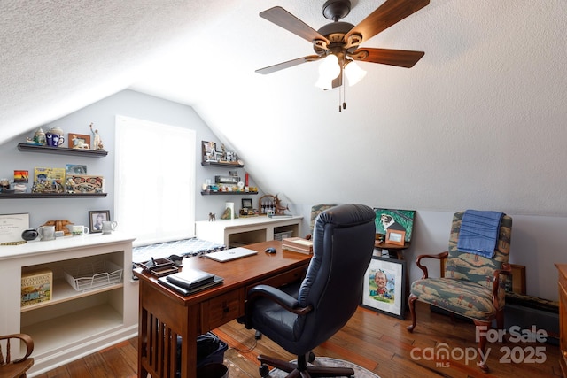 home office with ceiling fan, vaulted ceiling, wood-type flooring, and a textured ceiling