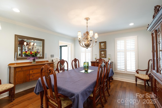 dining room with baseboards, dark wood finished floors, an inviting chandelier, recessed lighting, and ornamental molding