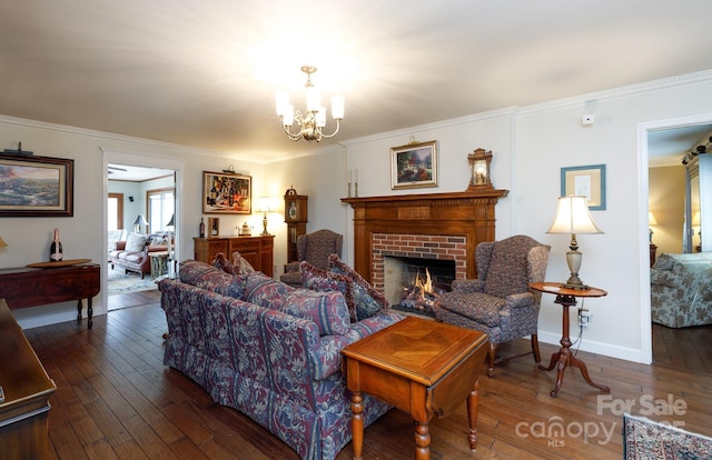 living area with a notable chandelier, wood-type flooring, and ornamental molding