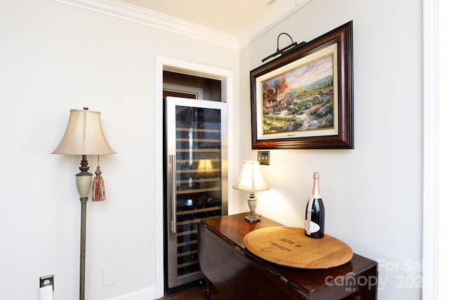 interior space with crown molding and wine cooler