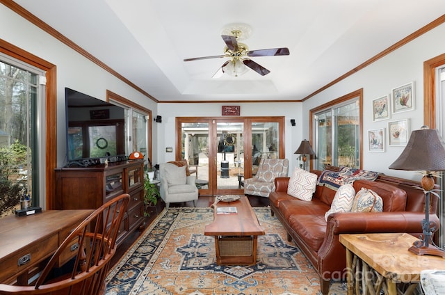 living room featuring plenty of natural light, ceiling fan, and crown molding