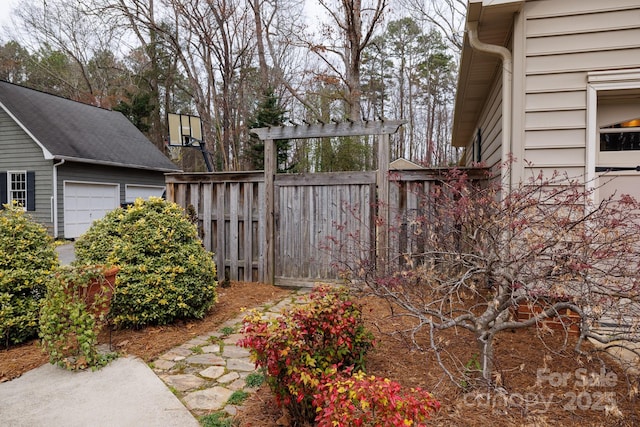 view of yard with a garage and fence