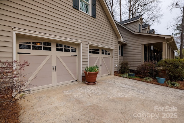 view of property exterior with concrete driveway and a garage