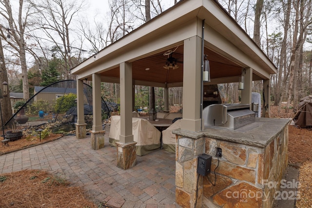 view of patio featuring a gazebo, area for grilling, and ceiling fan