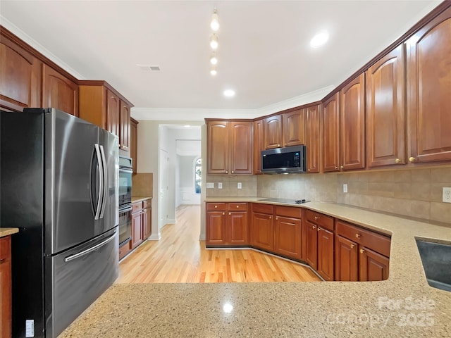 kitchen featuring tasteful backsplash, visible vents, light stone counters, light wood-style floors, and stainless steel appliances