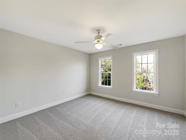 empty room featuring ceiling fan, baseboards, and carpet floors