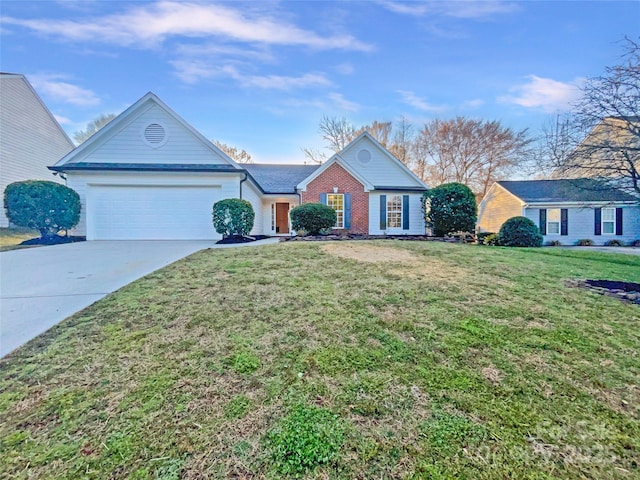 view of front of house featuring brick siding, driveway, a front yard, and a garage