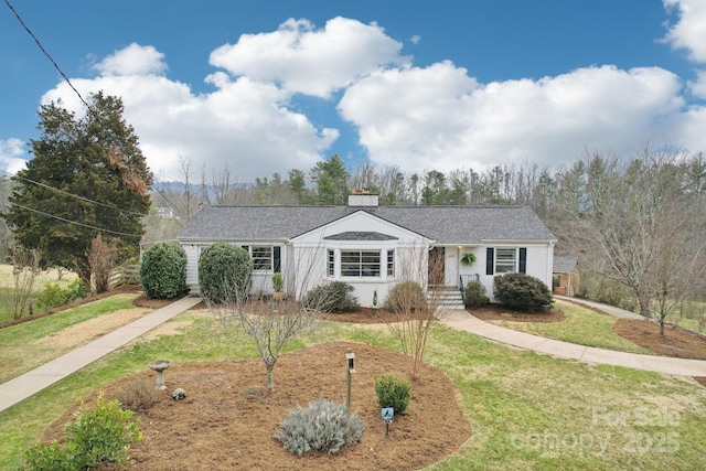 single story home with a front yard and a chimney