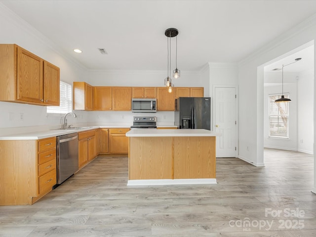 kitchen with stainless steel appliances, crown molding, light countertops, and a sink