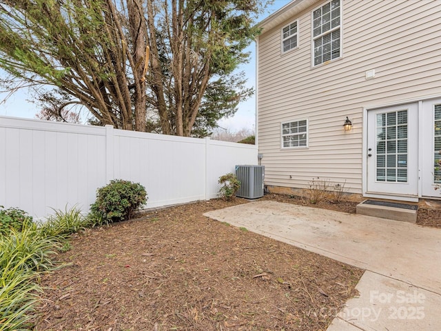 view of yard featuring cooling unit, a patio area, and fence private yard