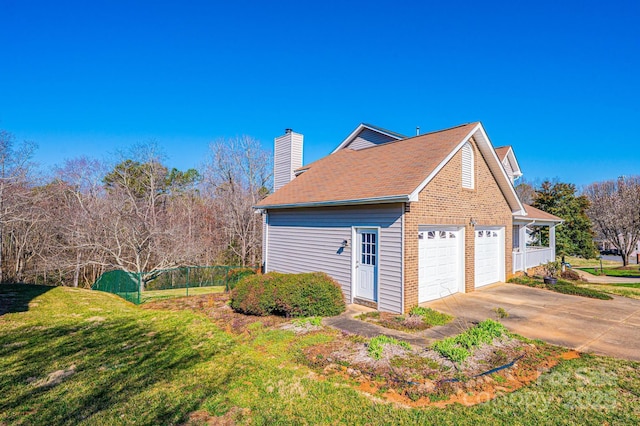 view of home's exterior featuring a lawn, driveway, and a chimney