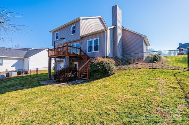 back of property with stairway, a yard, a fenced backyard, a chimney, and a deck