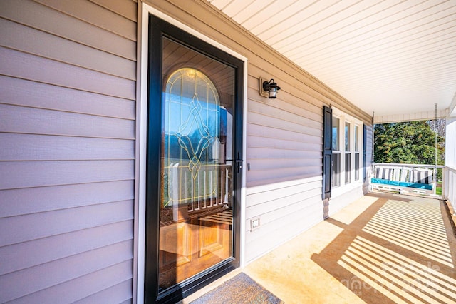 view of exterior entry with covered porch