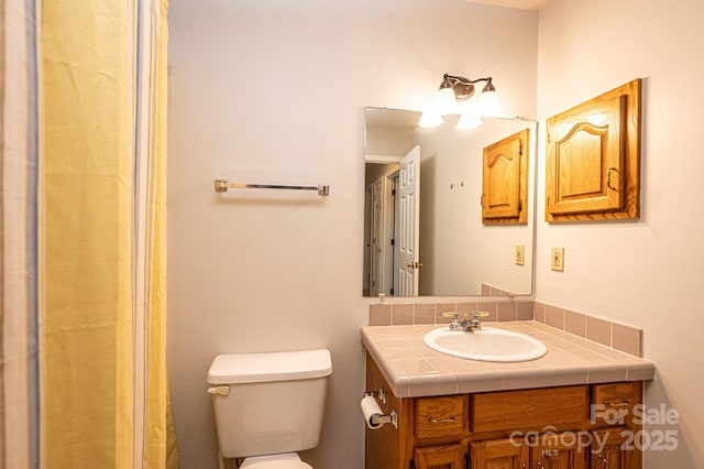 bathroom with toilet and vanity