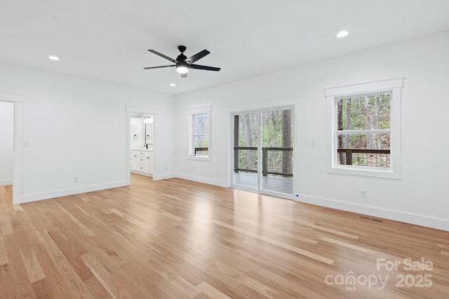 spare room featuring a ceiling fan, recessed lighting, light wood-type flooring, and baseboards