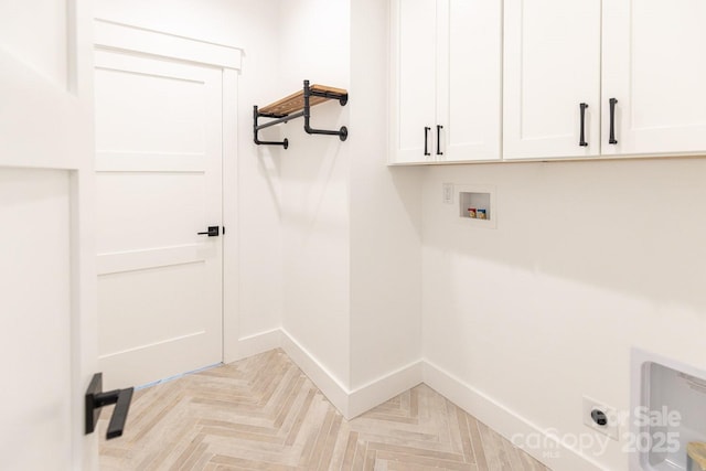 laundry room featuring hookup for a washing machine, cabinet space, baseboards, and hookup for an electric dryer