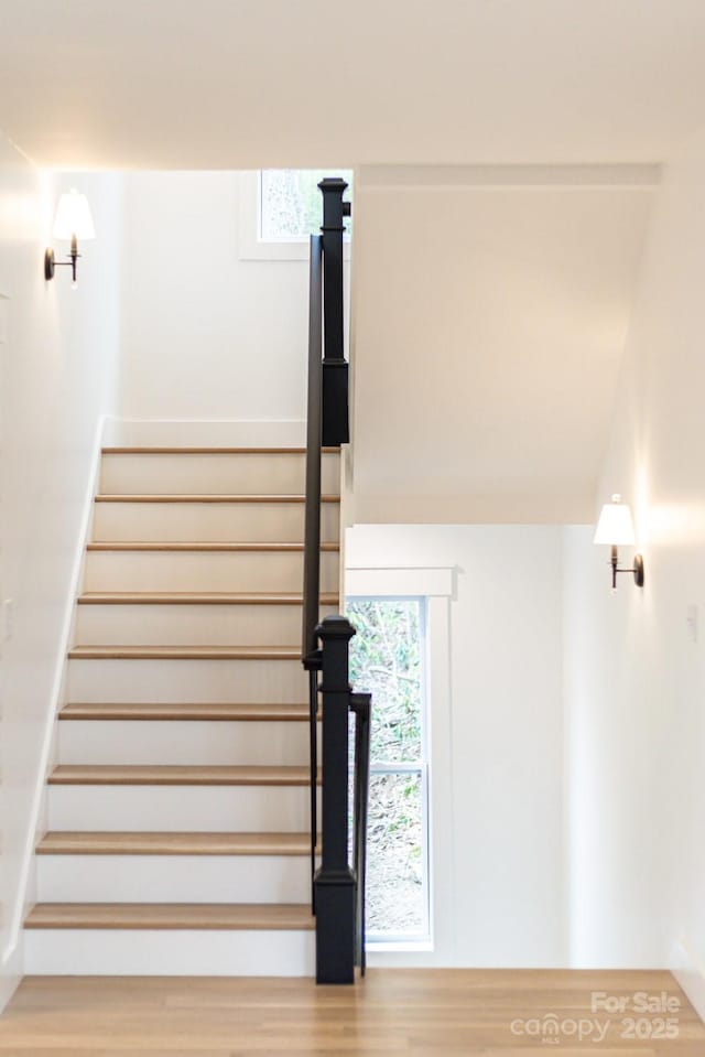 stairway with wood finished floors