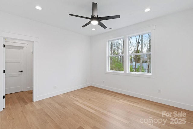 unfurnished room featuring recessed lighting, light wood-style floors, visible vents, and baseboards