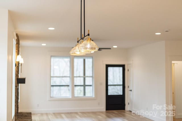 interior space with recessed lighting, baseboards, and wood finished floors