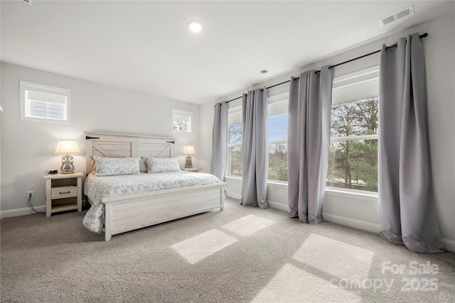 bedroom with visible vents, baseboards, and carpet