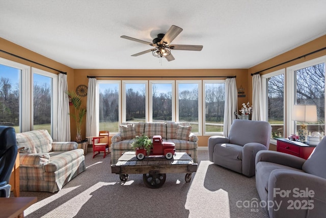 living area with carpet flooring and a ceiling fan