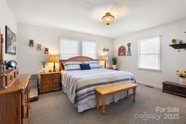 carpeted bedroom featuring visible vents, baseboards, and a textured ceiling