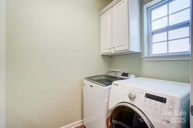 washroom with washer and clothes dryer, cabinet space, and baseboards