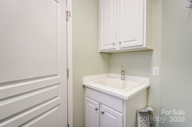 clothes washing area with a sink