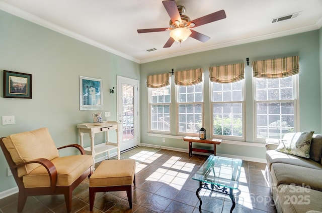 sitting room featuring baseboards, visible vents, and ornamental molding