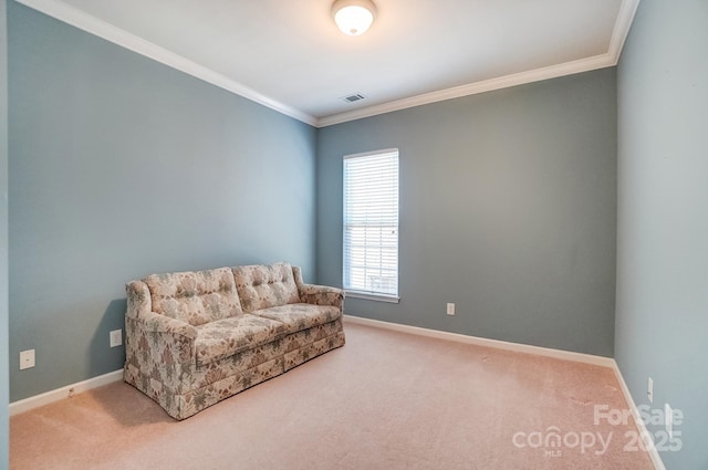 sitting room with carpet flooring, visible vents, baseboards, and ornamental molding