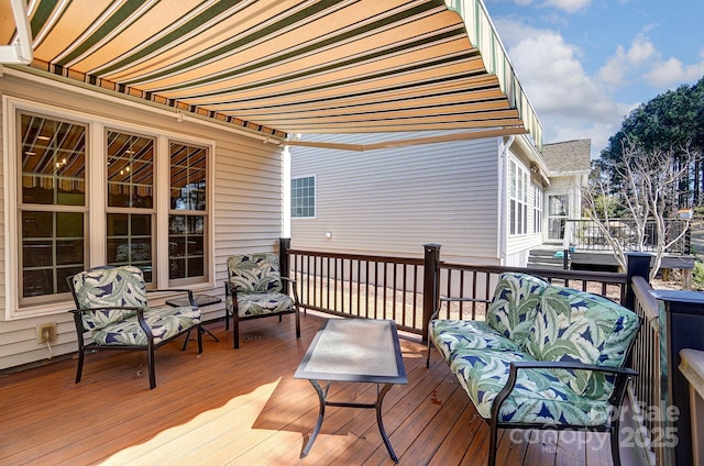 wooden terrace with an outdoor hangout area