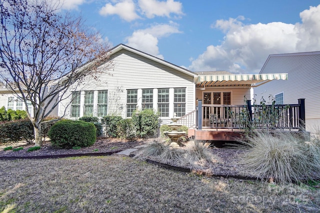 back of house with a wooden deck