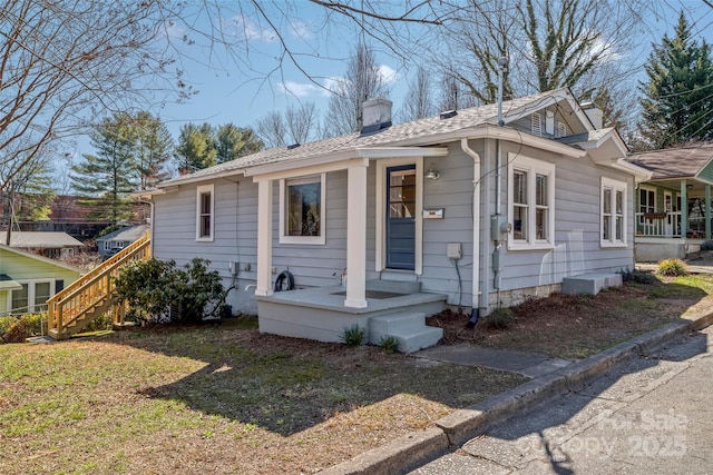 view of front of house featuring a front yard and a chimney