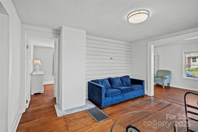 living room featuring visible vents and wood-type flooring