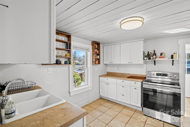 kitchen with open shelves, stainless steel electric range oven, white cabinetry, and a sink