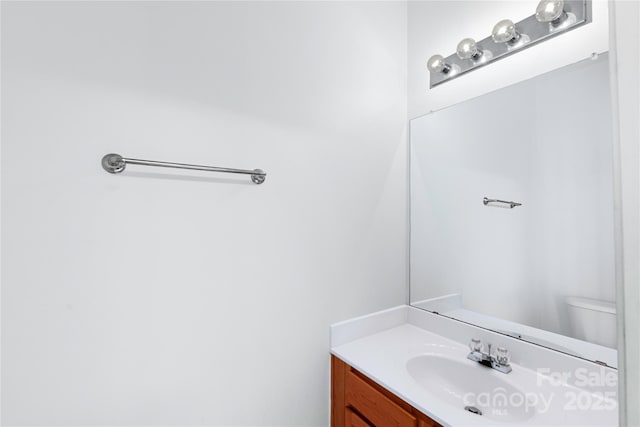 bathroom with toilet and vanity