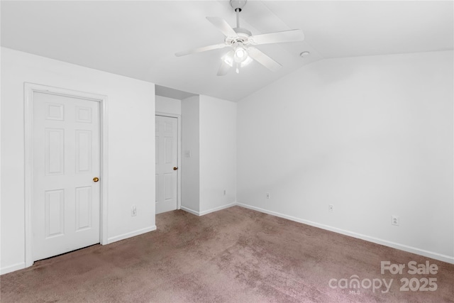 unfurnished bedroom featuring baseboards, lofted ceiling, carpet, and a ceiling fan