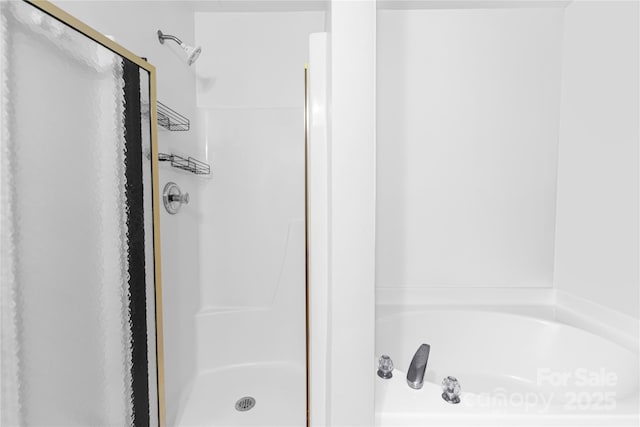 bathroom featuring a garden tub and a stall shower